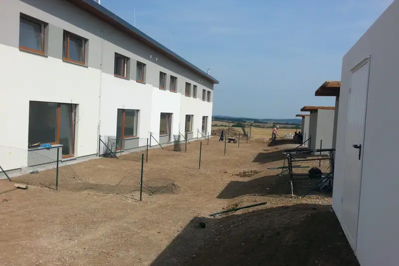 Sloupky budoucího oplocení zahrad u řadových domů