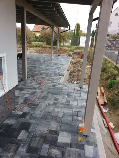 Terasa ze šedé dlažby pod přístřeškem